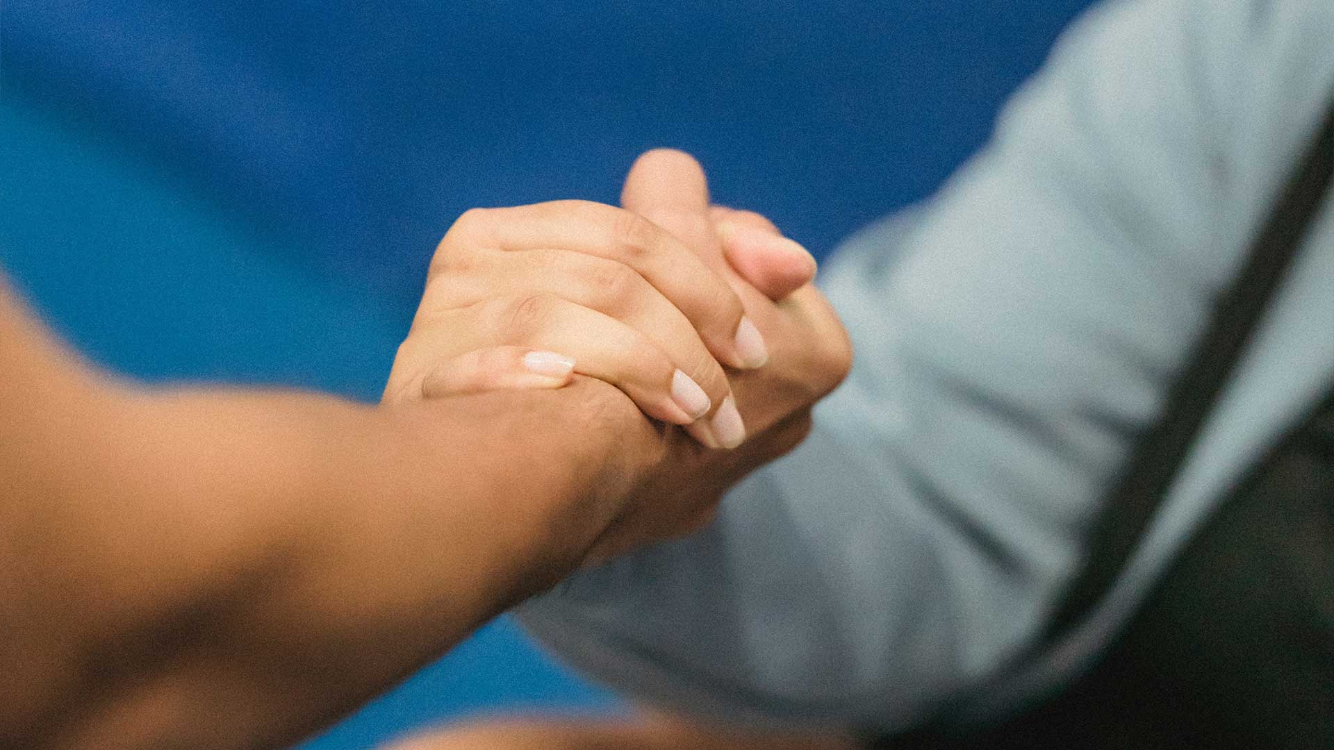 Two people holding hands
