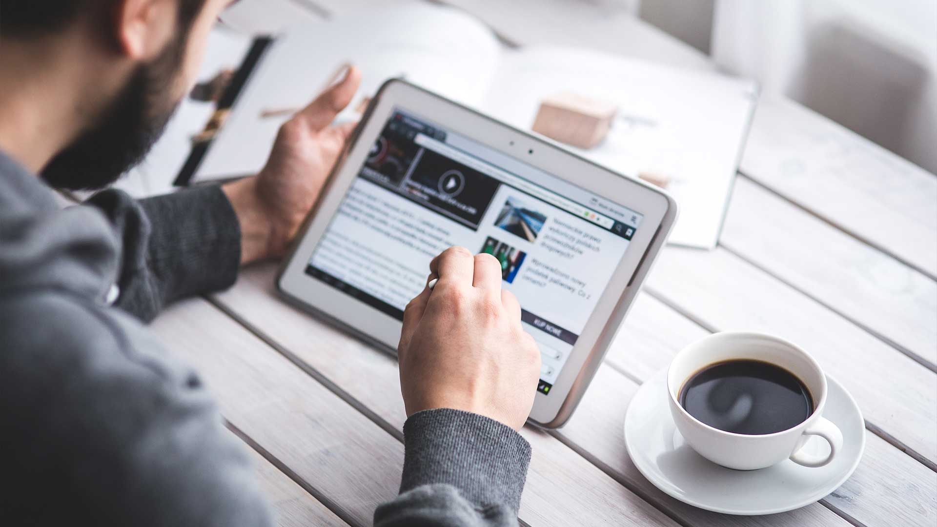 A person reading news on their iPad